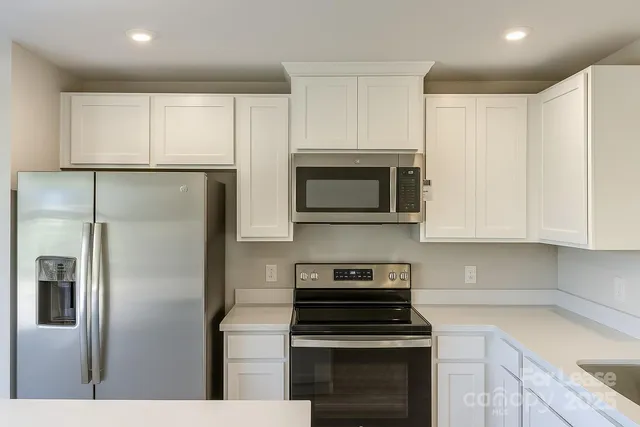 a kitchen with cabinets and stainless steel appliances