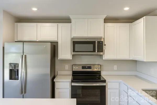 a kitchen with cabinets and stainless steel appliances