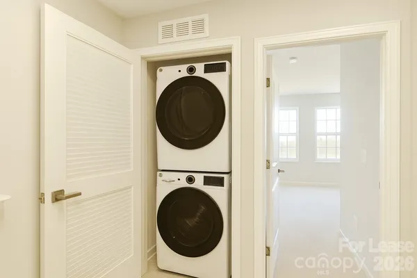 a view of a hallway with washer and dryer