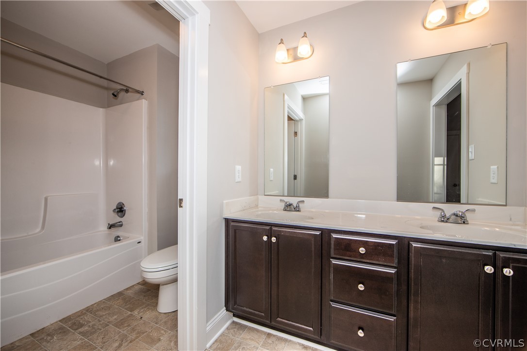 6711 Cross County Road Gum Spring, VA 23065 - Photo 10 of 21 The primary bathroom boasts dual vanities, tub/sho
