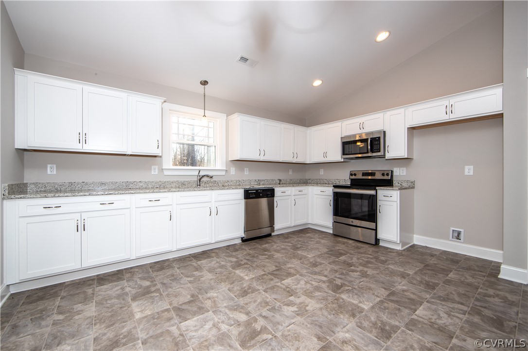 The spacious kitchen offers recessed lighting, dur