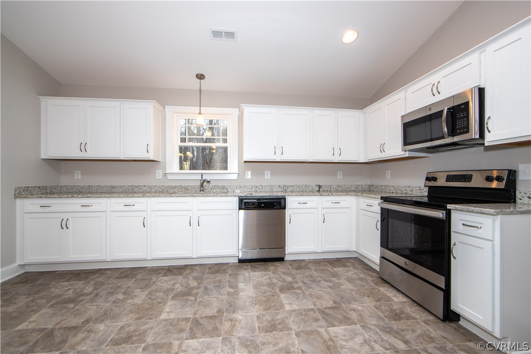 The kitchen also offers an abundance of cabinets f