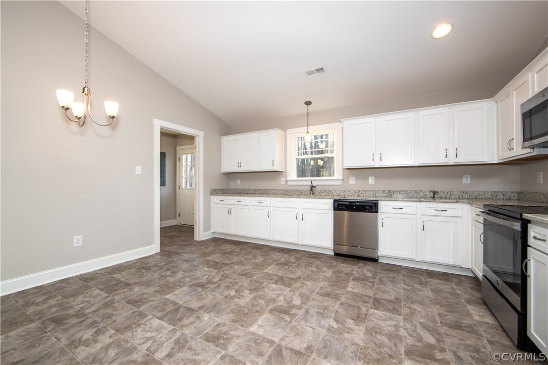 The kitchen is adjacent to the laundry and has eas