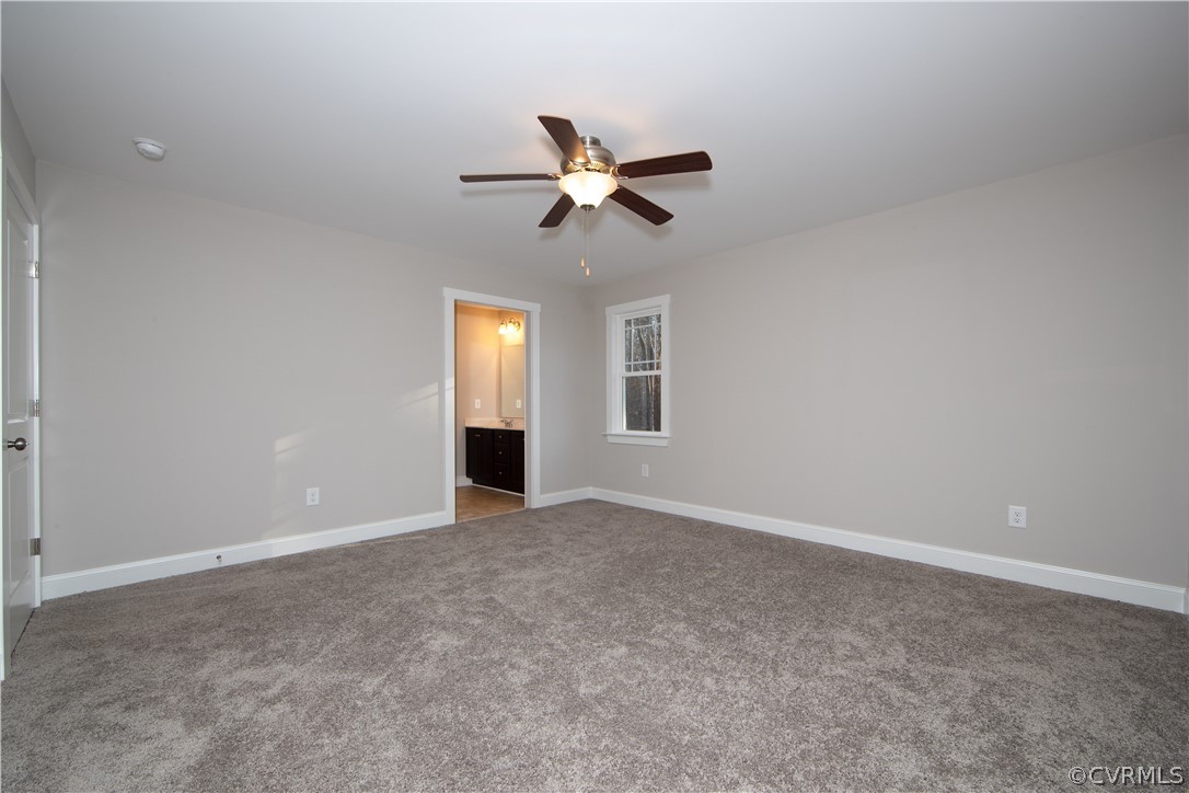 6711 Cross County Road Gum Spring, VA 23065 - Photo 8 of 21 The spacious primary bedroom boasts a sophisticate