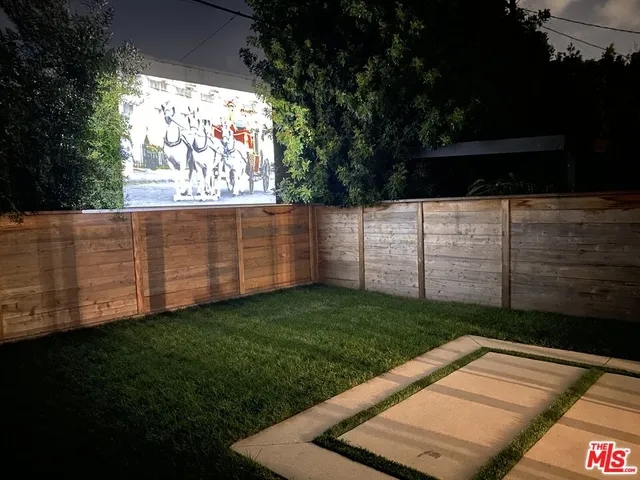 a view of a backyard with sitting area