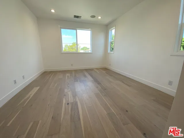 a bathroom with a sink a toilet and a large mirror