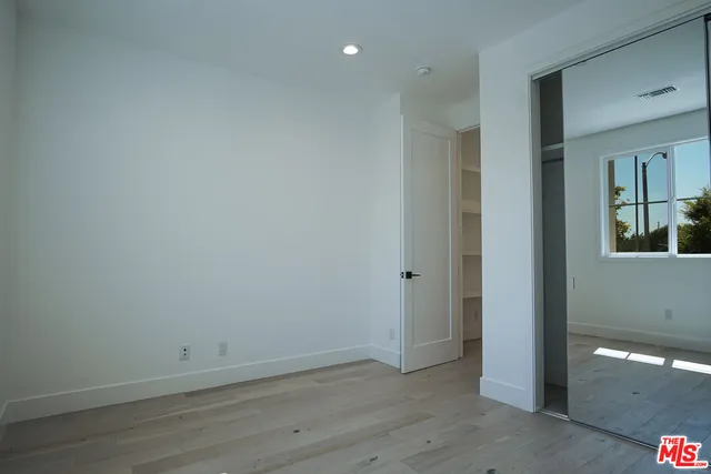 a view of an empty room and closet area