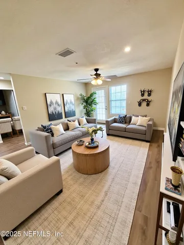 a living room with furniture and a large window