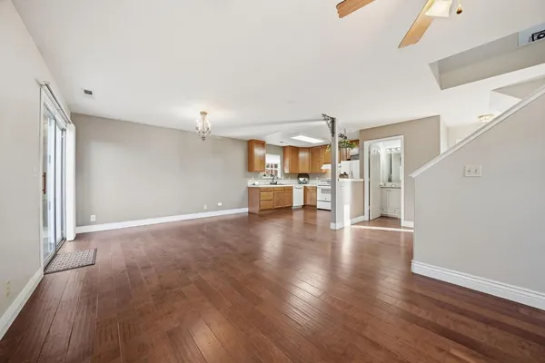 a view of a livingroom with wooden floor and furniture