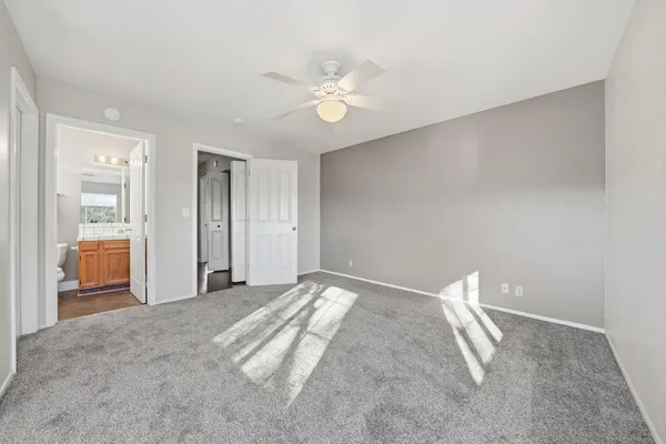 a view of a livingroom with a ceiling fan and window