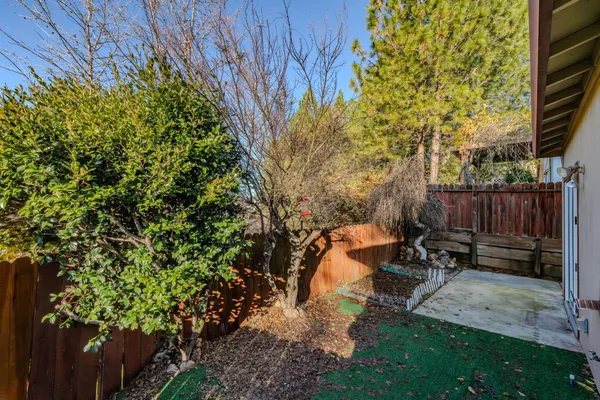 a view of a bench in backyard of house