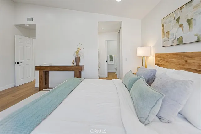 a bedroom with a bed and a lamp on table