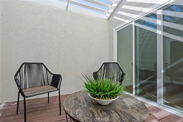 a view of a hallway with wooden floor and a potted plant