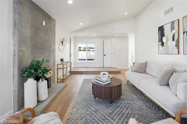 a living room with furniture and a potted plant