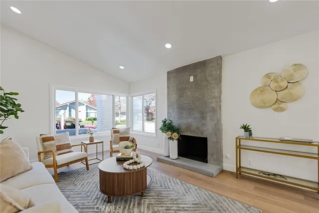 a living room with furniture a window and a fireplace