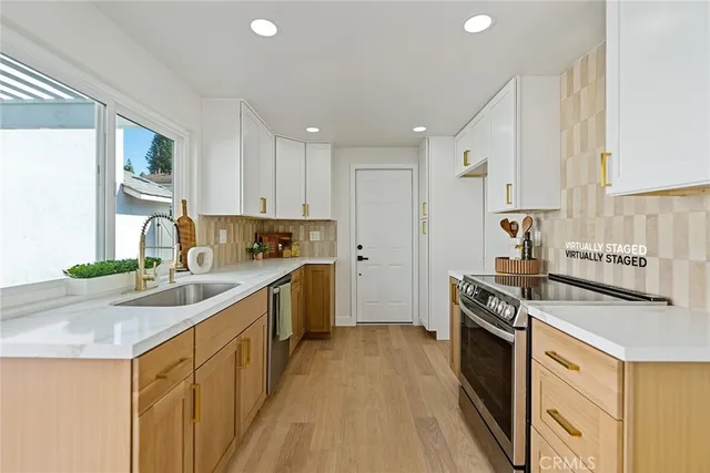 a kitchen with a sink stove top oven and refrigerator