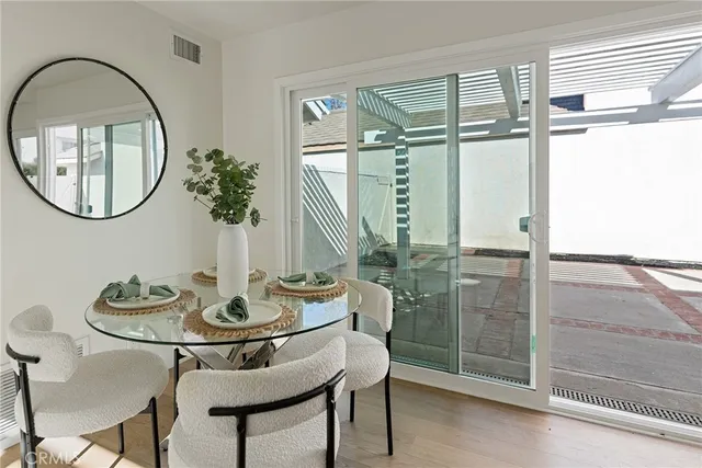 a dining room with furniture and a floor to ceiling window