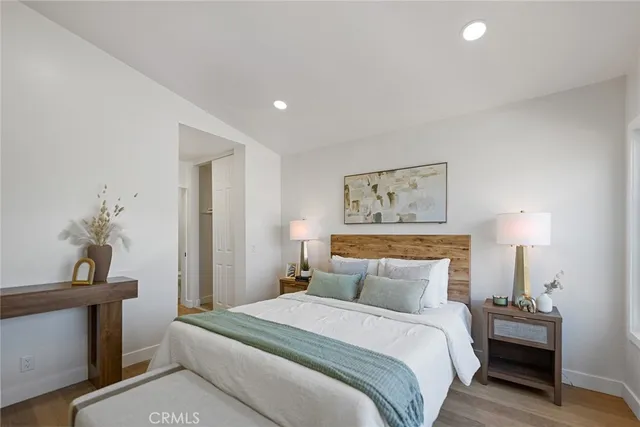 a bedroom with a bed and a painting on the wall