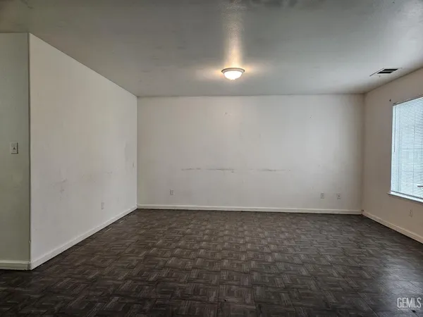 an empty room with a empty space and a window