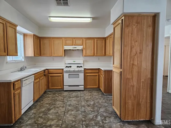 a kitchen with a sink cabinets and window