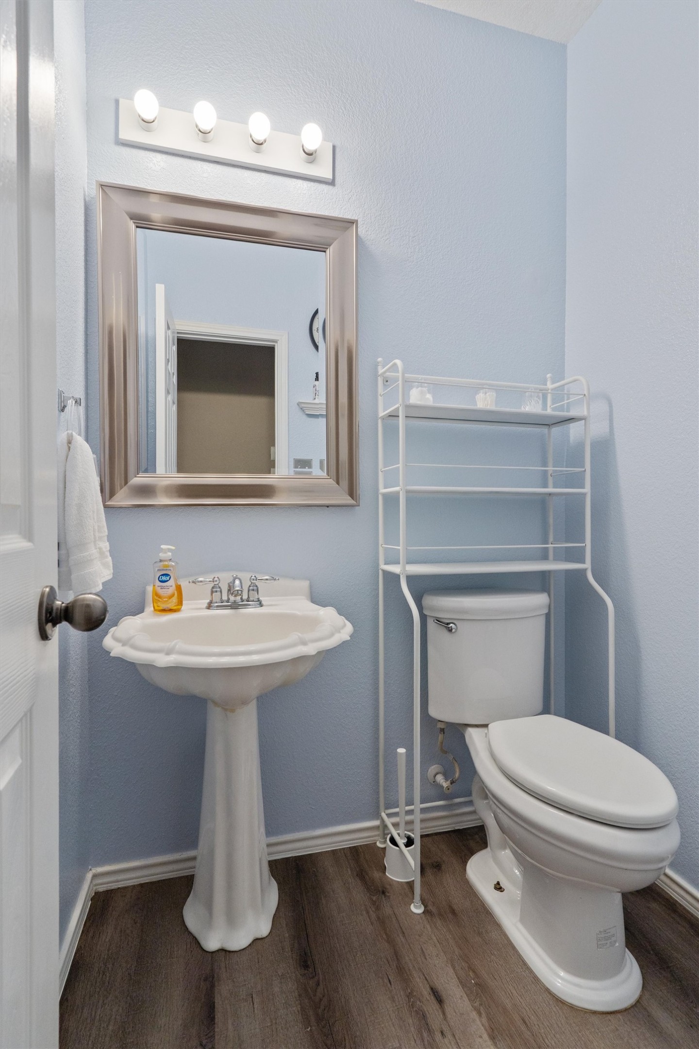 1833 Thompson Trail Round Rock, TX 78664 - Photo 14 of 40 A well-appointed lavatory with a classic pedestal sink, complemented by light blue walls and durable flooring.
