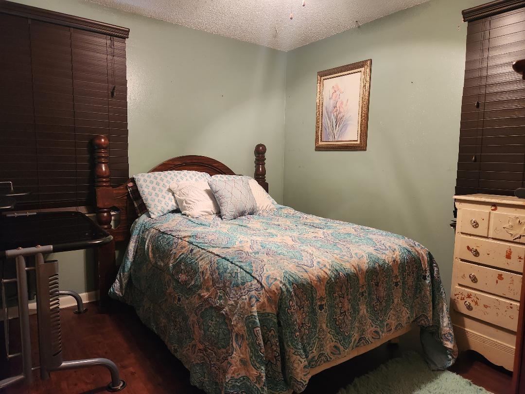 188 Ivan Road Memphis, TN 38109 - Photo 4 of 18 a bedroom with a bed and a night stand