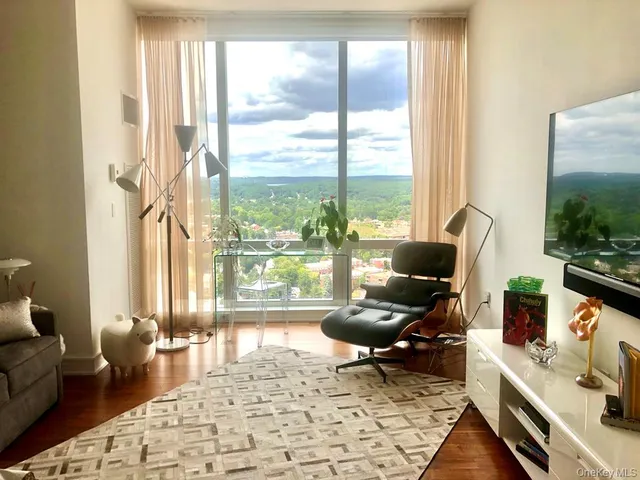 a living room with furniture and a floor to ceiling window