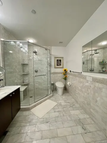 a bathroom with a shower toilet and sink