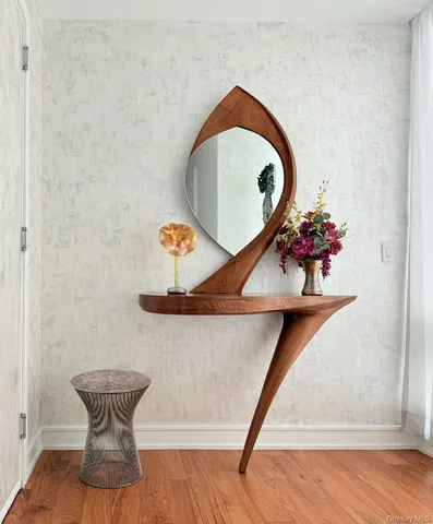 a room with a potted plant and a wooden floor