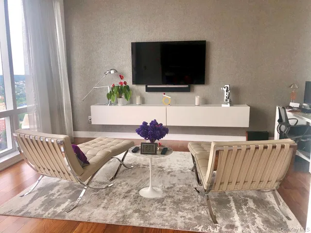 a living room with furniture and a flat screen tv