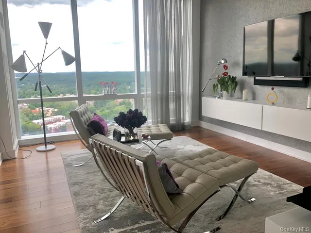 a living room with furniture and a potted plant