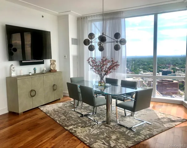 a dining room with furniture and a large window