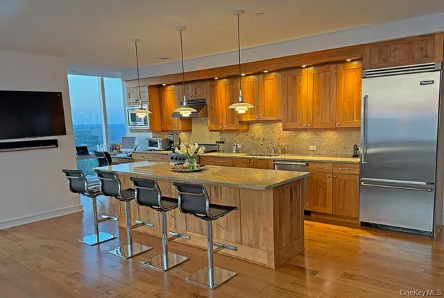 a kitchen with a table chairs refrigerator and microwave