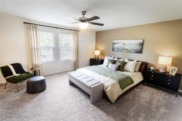 a spacious bedroom with a bed and a chandelier