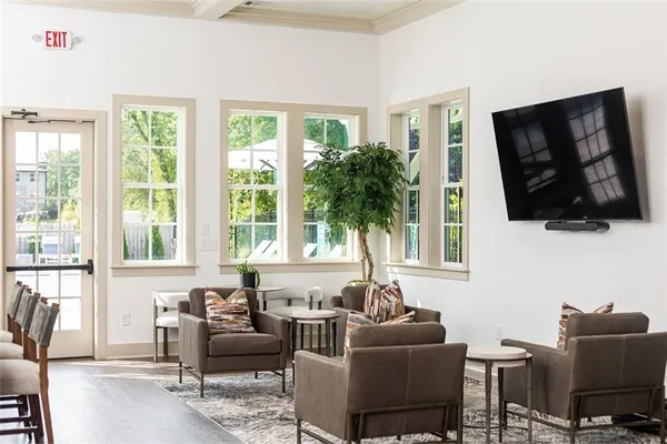 a living room with furniture tv and a window