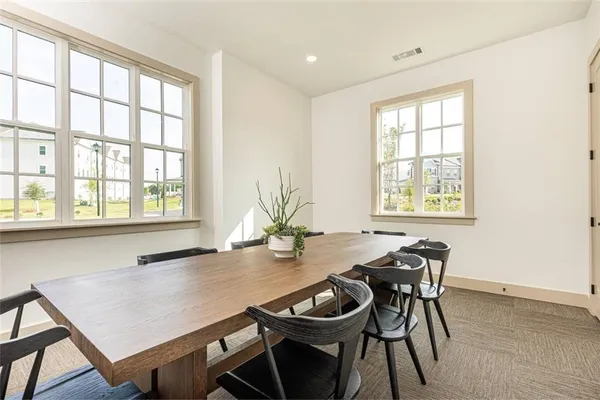 a view of a dining room with furniture and window