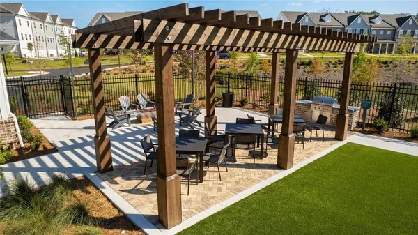 a view of swimming pool with outdoor seating and a patio