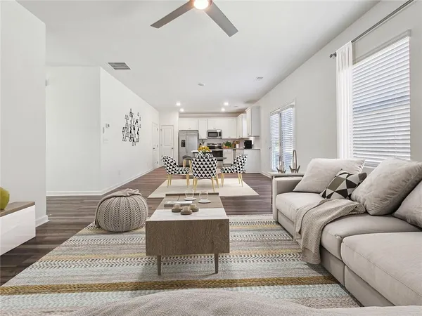 a living room with furniture a couch and a window