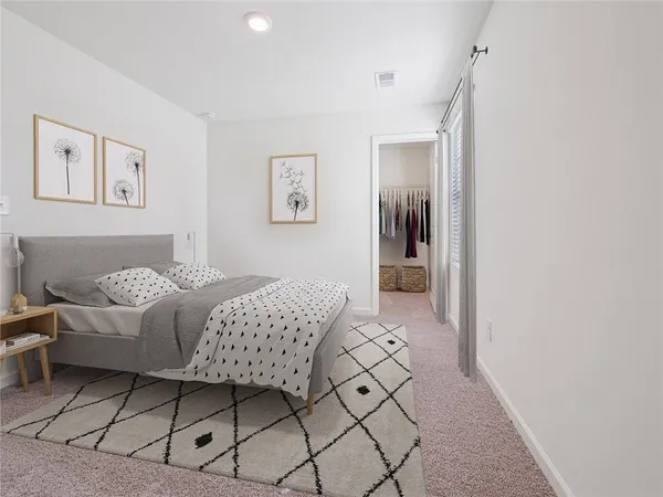 a bedroom with a bed and a painting on the wall
