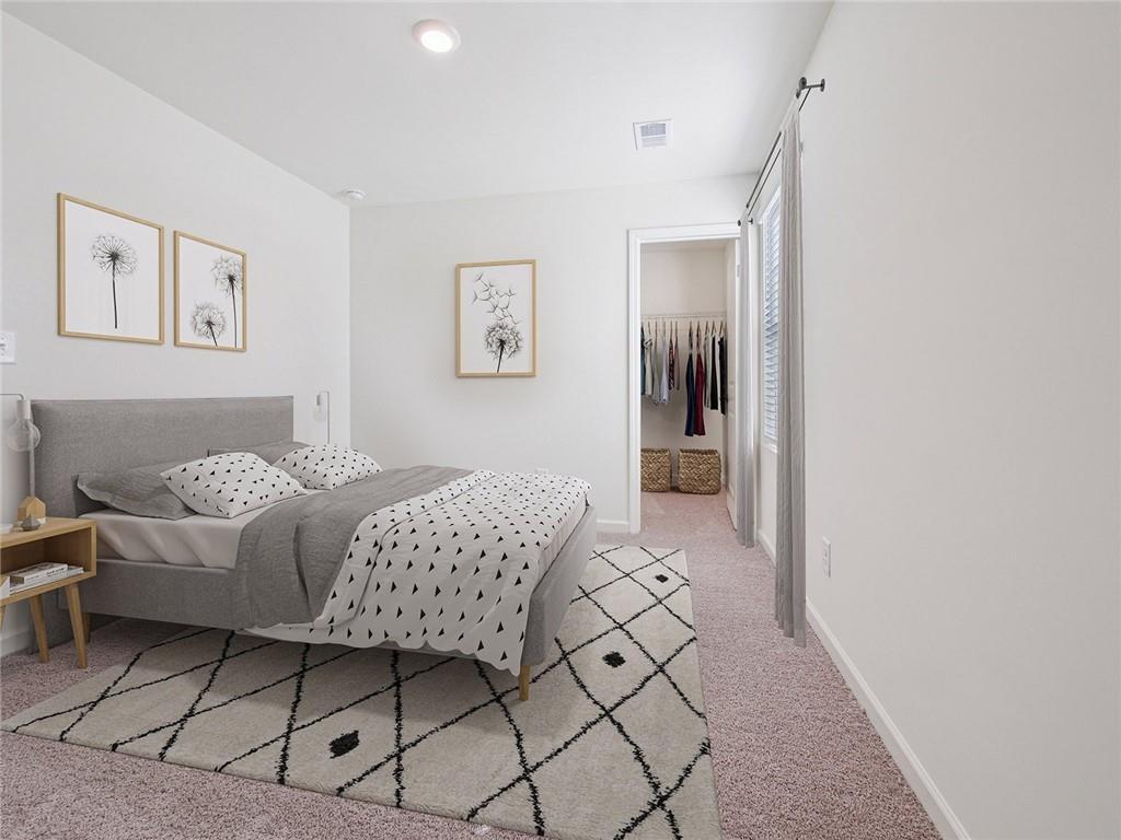 3373 Fence Road Northeast, Unit D2 Dacula, GA 30019 - Photo 28 of 36 a bedroom with a bed and a painting on the wall