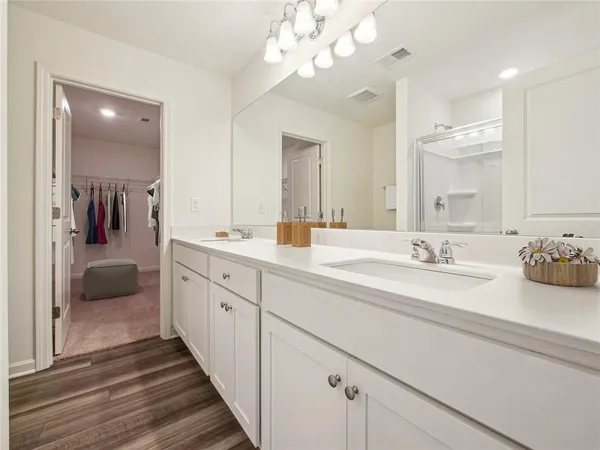 a spacious bathroom with a double vanity sink and a mirror