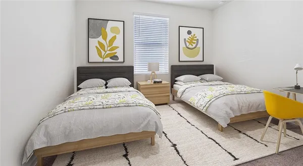 a bedroom with two beds and a lamp