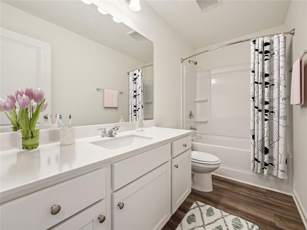3373 Fence Road Northeast, Unit D2 Dacula, GA 30019 - Photo 34 of 36 a bathroom with a sink a toilet and shower
