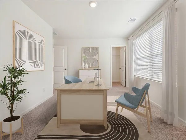 a living room with furniture and a potted plant