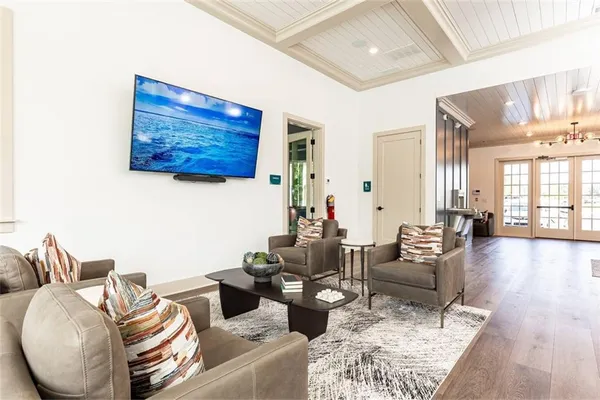 a living room with furniture and wooden floor