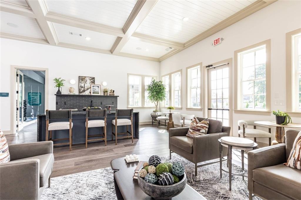 3373 Fence Road Northeast, Unit D2 Dacula, GA 30019 - Photo 7 of 36 a living room with furniture potted plant and a large window