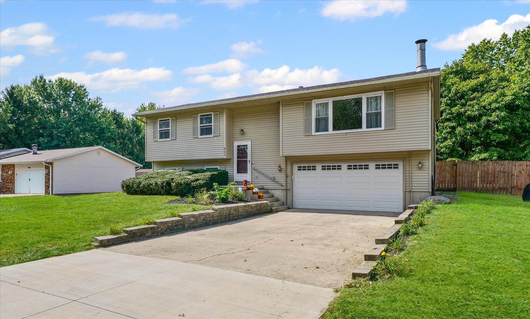 a front view of house with yard and trees