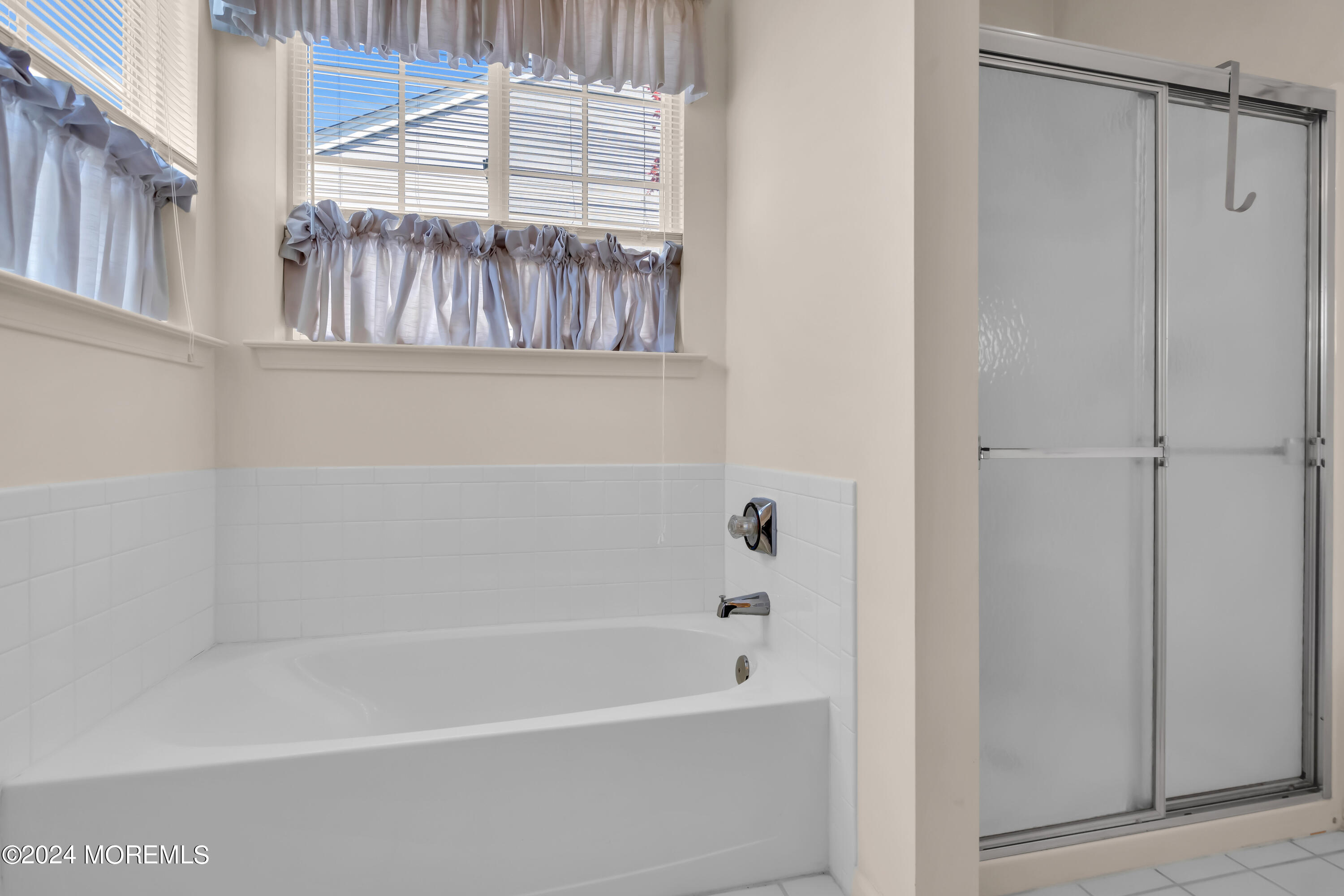 89 Quail Road Barnegat, NJ 08005 - Photo 29 of 37 a bathroom with a bathtub a window and a shower