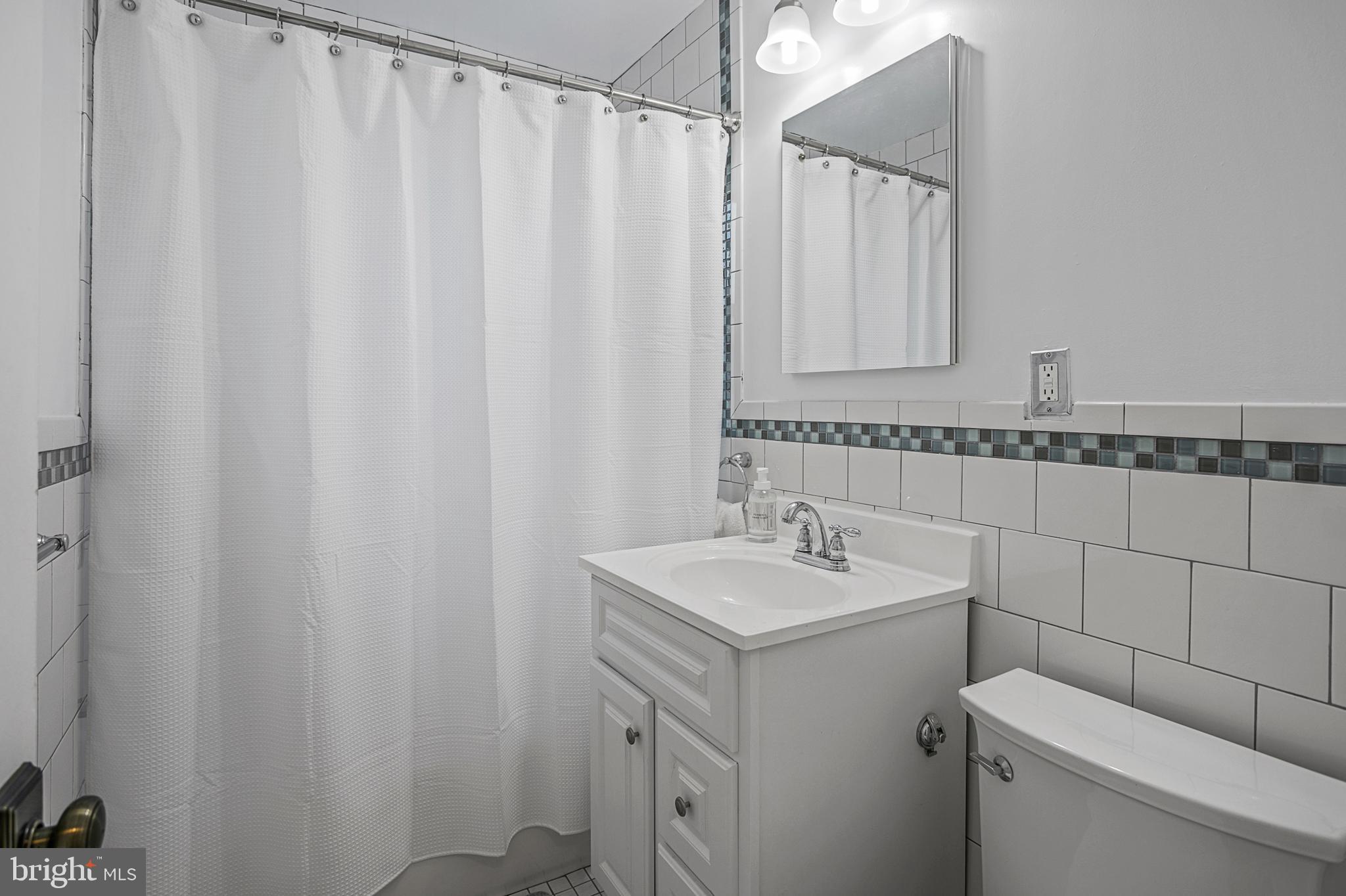 4029 Benton Street Northwest, Unit 101 Washington, DC 20007 - Photo 12 of 28 White Tiled Bathroom