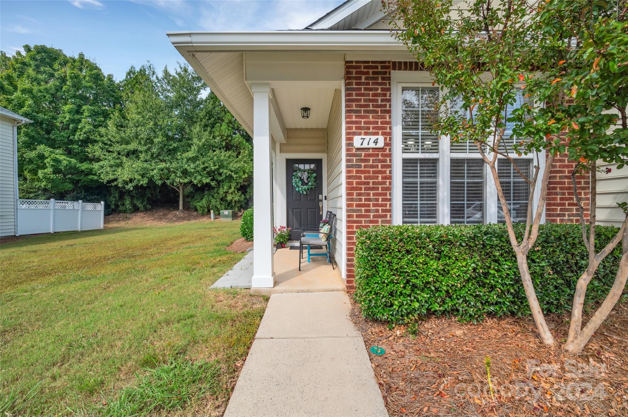 714 Shellstone Place Fort Mill, SC 29708 - Photo 3 of 24 a view of a house with a small yard plants and large tree